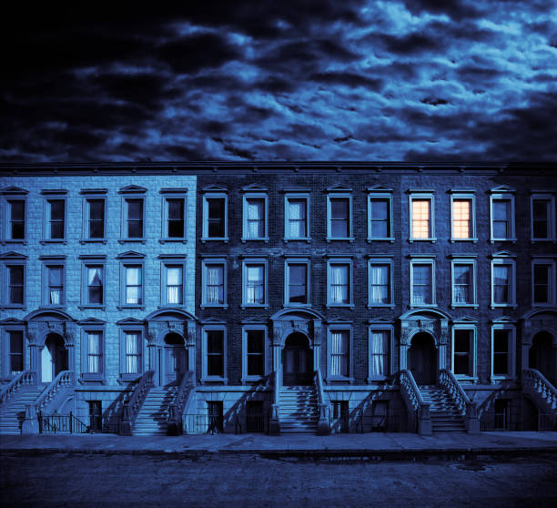 Row of Brownstone Houses Against Cloudy Night Sky stock photo