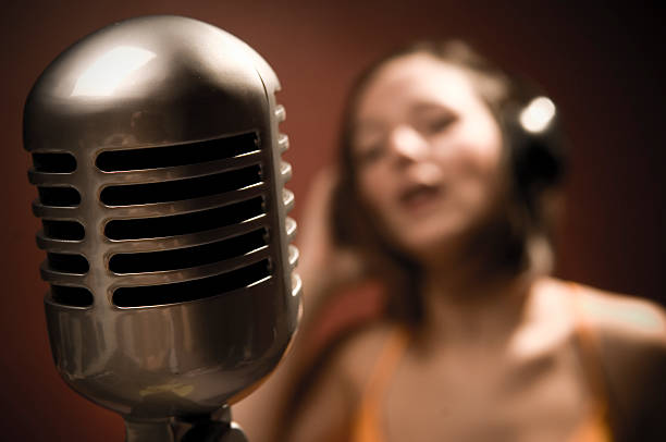 istock Shallowly Focused Young Woman Singing into Microphone 108194937