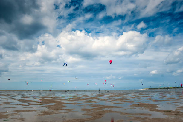 istock people kite surfing on the beach 1081949390