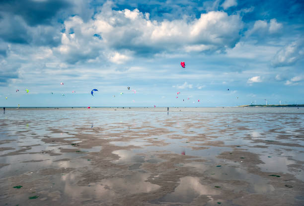 istock people kite surfing on the beach 1081949392