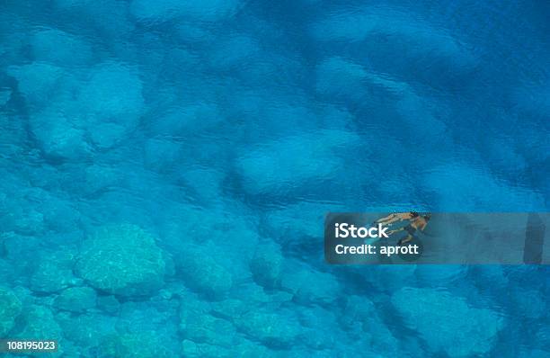 Man And Woman Snorkelling In Blue Mediterranean Sea Stock Photo - Download Image Now