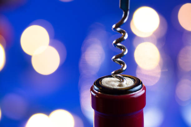 Wine Bottle Corkscrew Detail - Detail with spiral corkscrew and out of focus background lights.