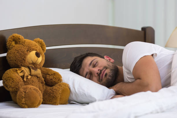 istock The man sleeping near the soft toy 1081952886