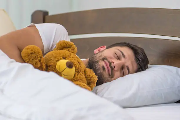 The man sleeping near the toy