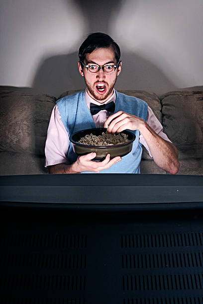 istock Nerdy Guy Watching A Movie At Home 108195347