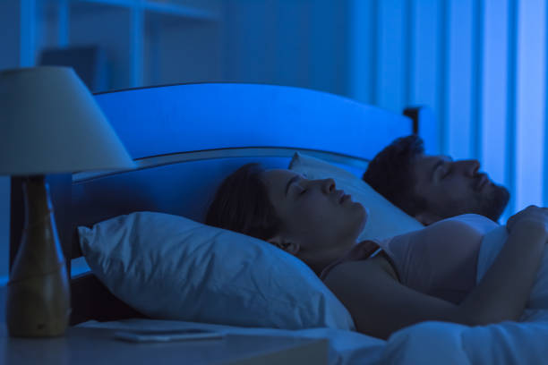 istock The young couple sleeping in the bed. night time 1081953600