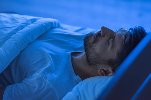 istock The man sleeping in the bed. night time 1081953720