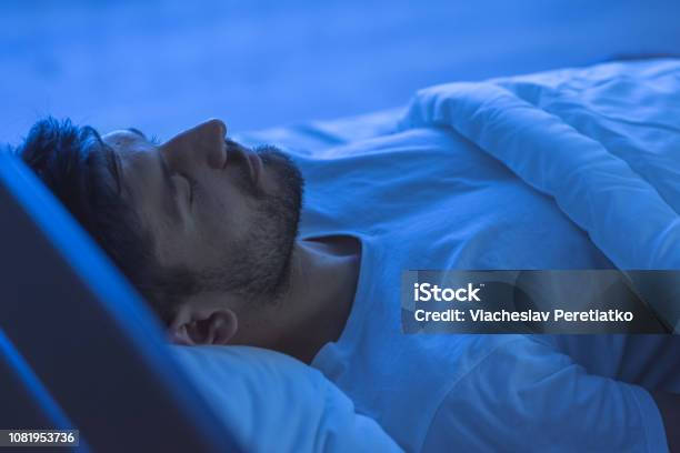 The Man Sleeping In The Bed Night Time Stock Photo - Download Image Now - Sleeping, Men, Night