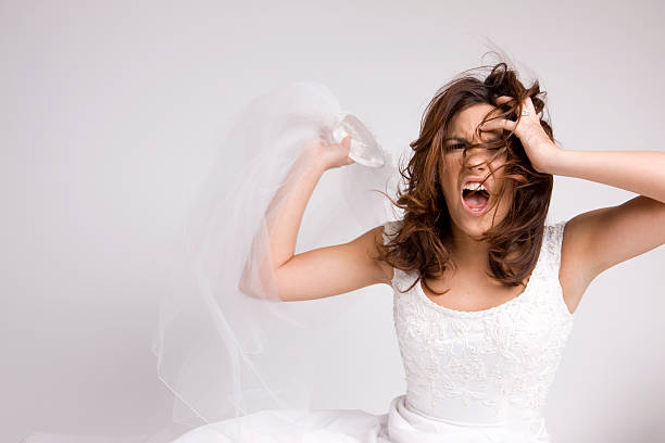 Angry Screaming Bride Throwing Veil stock photo