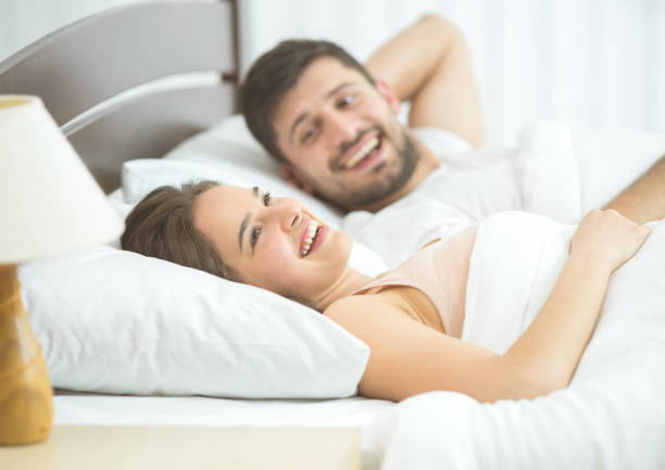 istock The happy couple lay in the comfortable bed 1081957870