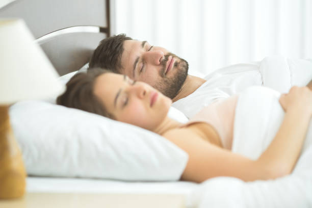 istock The man and woman sleeping in the comfortable bed 1081958024