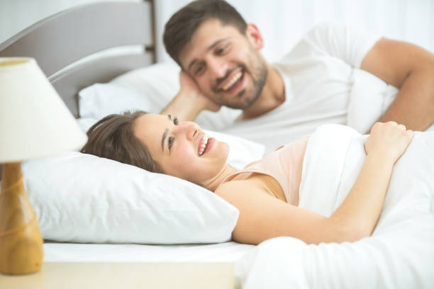 istock The happy couple lay in the comfortable bed 1081958090