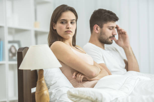 istock The sad couple sit on the bed 1081958232