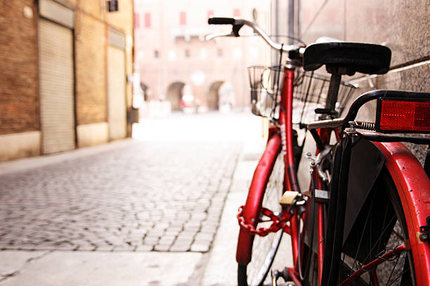 Red Bicycle Leaning Against Wall on Italian Street  bologna photos stock pictures, royalty-free photos & images