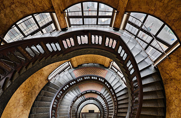 istock Looking Down at Spiral Marble Staircase with Large Windows 108195841