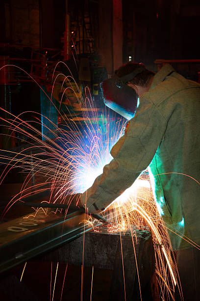 istock Arc Welder Wearing Protective Mask with Sparks Flying 108195887