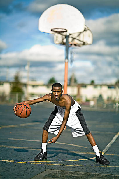 istock Young Man Playing Basketball on Court Outside 108196113