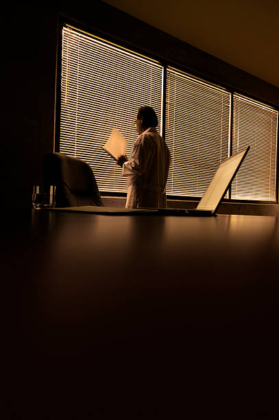 istock Male Doctor Looking at File Folder in Dark Office, Toned 108196228