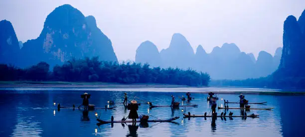 Photo of People fishing in the lake near the mountains
