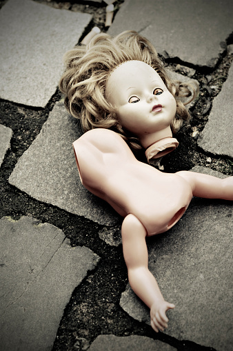spooky doll on granite cobblestone... found this after the flea market has gone. vignetting is intend.