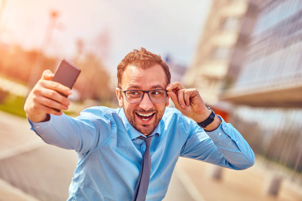 istock Funny businessman using smartphone outdoors. 1081965896