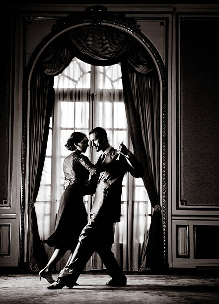 Young Couple Dancing Tango in Elegant Room, Toned stock photo