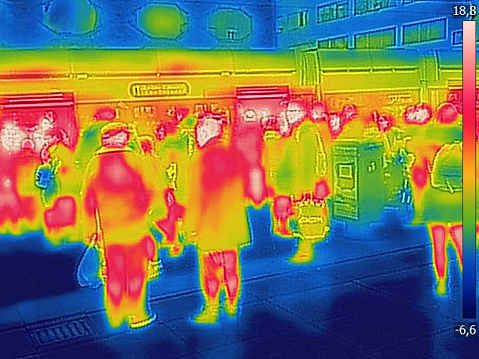 Infrared Thermal image of people at the city railway station, on a cold winter day