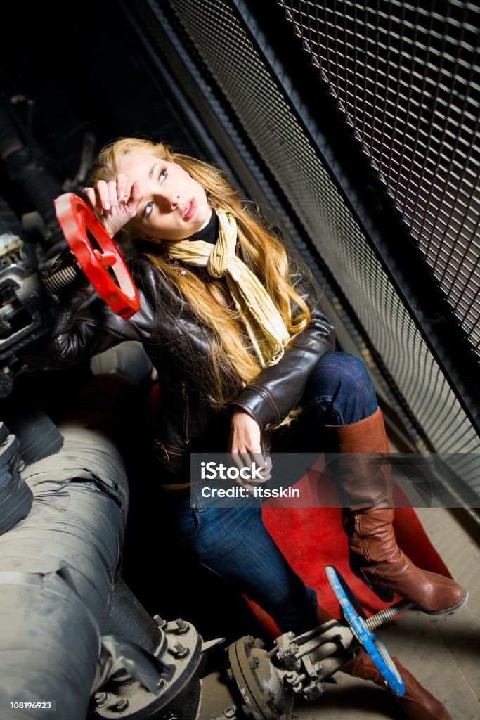 Jovem mulher sentada na Industrial tubos - Royalty-free Boca de Incêndio Foto de stock