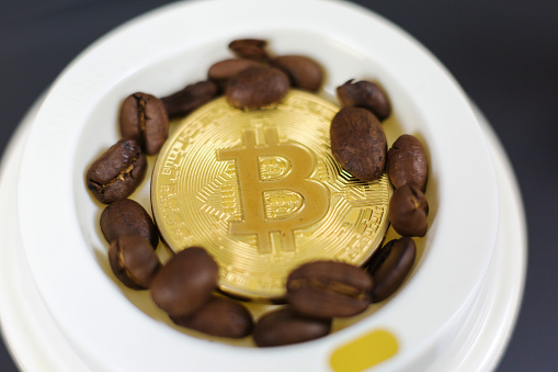 Bitcoin coin in a close-up shot, digital currency coffee payment concept. Slovenia,December 1st,2018.