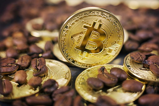 Bitcoin coins in a close-up shot, digital currency coffee payment concept. Slovenia,December 1st,2018.