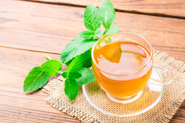 istock Fresh mint tea with leaves on wooden table 1081969726