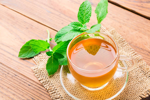 istock Fresh mint tea with leaves on wooden table 1081969734