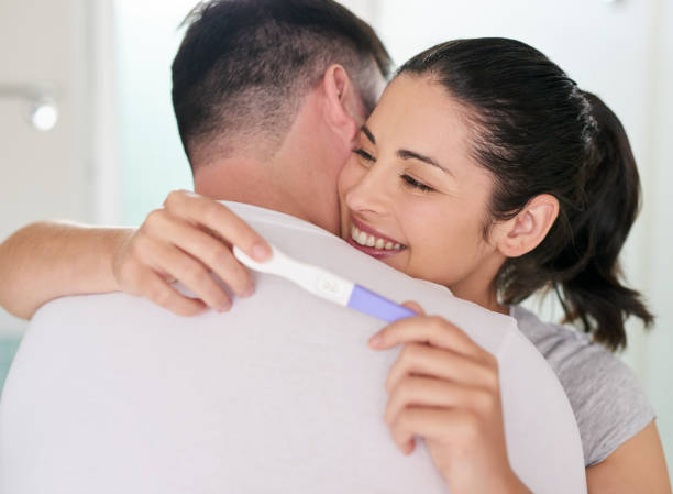 We're happy about becoming new parents Shot of a young couple looking happy after taking a home pregnancy test mum new boyfriend stock pictures, royalty-free photos & images