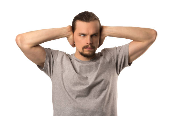 istock Bearded attractive caucasian guy coverd his ears with his hands isolated on white 1081970990