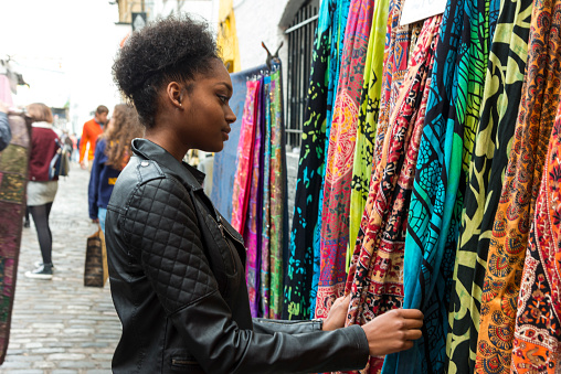 Young black woman shopping at the Camden market, London, UK
