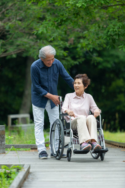 istock An old couple walking in a wheelchair 1081973438