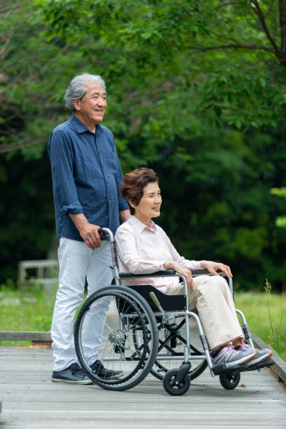 istock An old couple walking in a wheelchair 1081973464