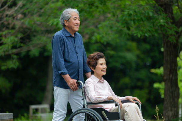 istock An old couple walking in a wheelchair 1081973468