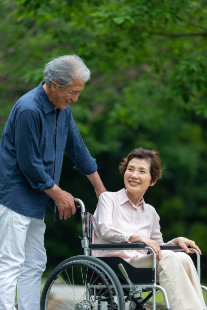 istock An old couple walking in a wheelchair 1081973474