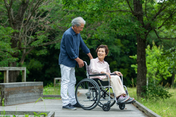 istock An old couple walking in a wheelchair 1081973478