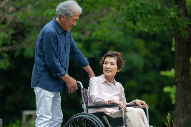 istock An old couple walking in a wheelchair 1081973484