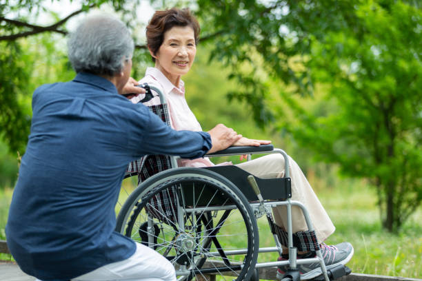 istock An old couple walking in a wheelchair 1081973506