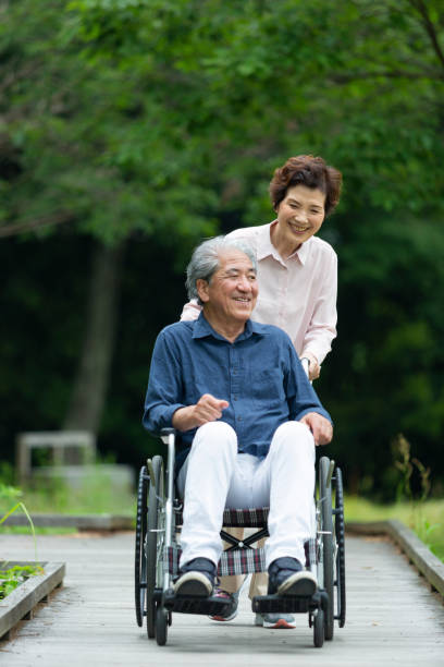 istock An old couple walking in a wheelchair 1081973536