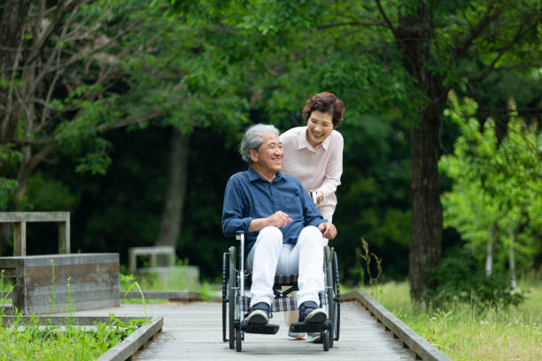 istock An old couple walking in a wheelchair 1081973556