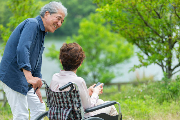 istock An old couple walking in a wheelchair 1081973588