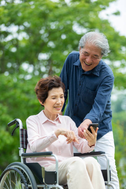 istock An old couple walking in a wheelchair 1081973598