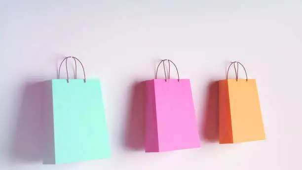 Photo of Colorful shopping bags hanging on the wall concept