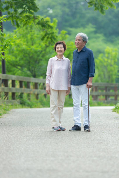 istock An old couple walking in the park 1081973868