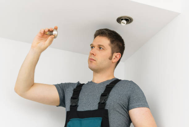 istock Certified electrician checking burned out light bulb. 1081974568