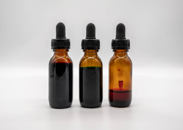 istock Three amber glass bottles with dropper isolated on white background. 1081976240